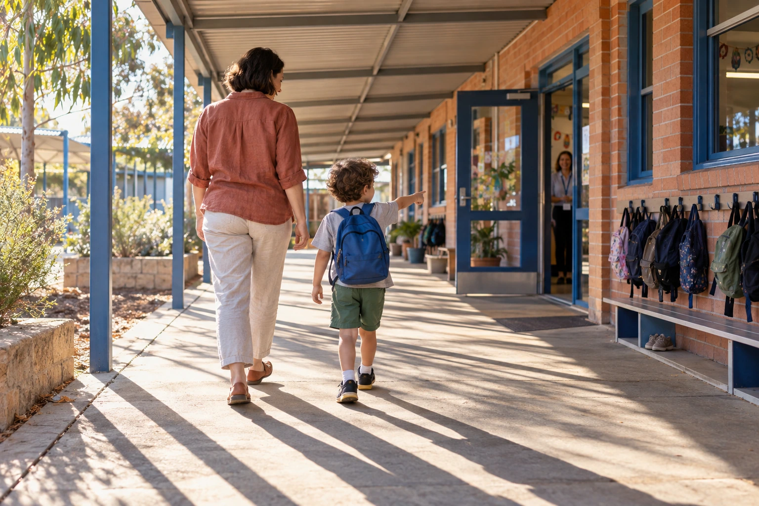 A child walking towards school with a parent.